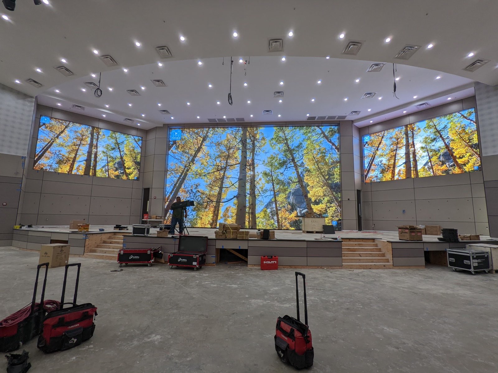 Curved LED wall lit up for content testing during an auditorium buildout