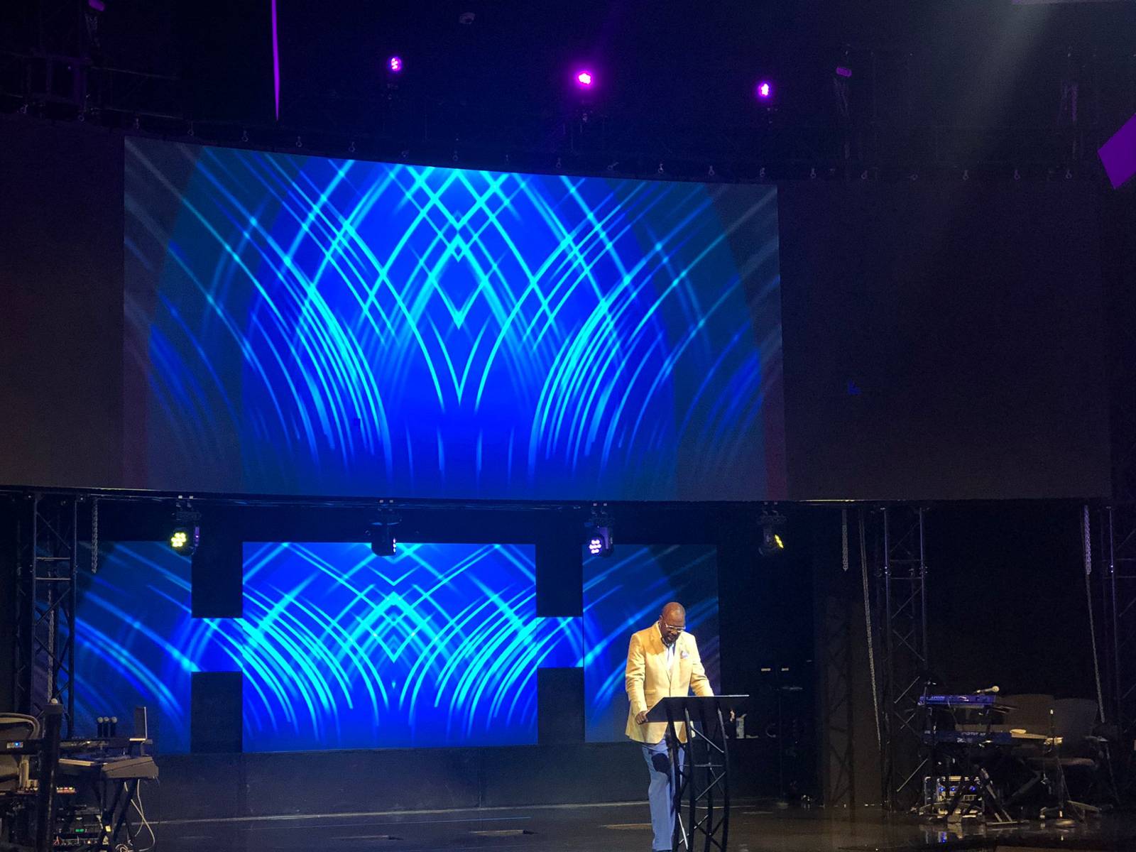 Church stage with upper and lower LED walls showing blue geometric content during service prep
