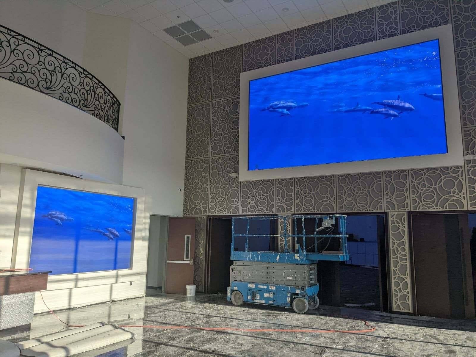 Grand lobby with two LED displays showing underwater content