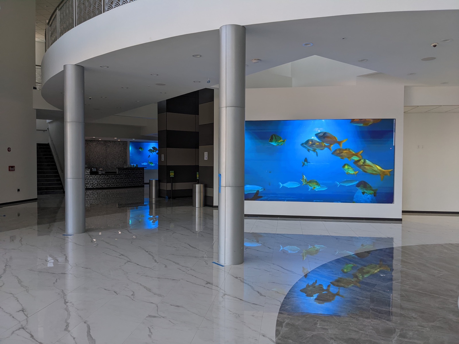 Venue lobby with a large LED feature wall showing aquarium content