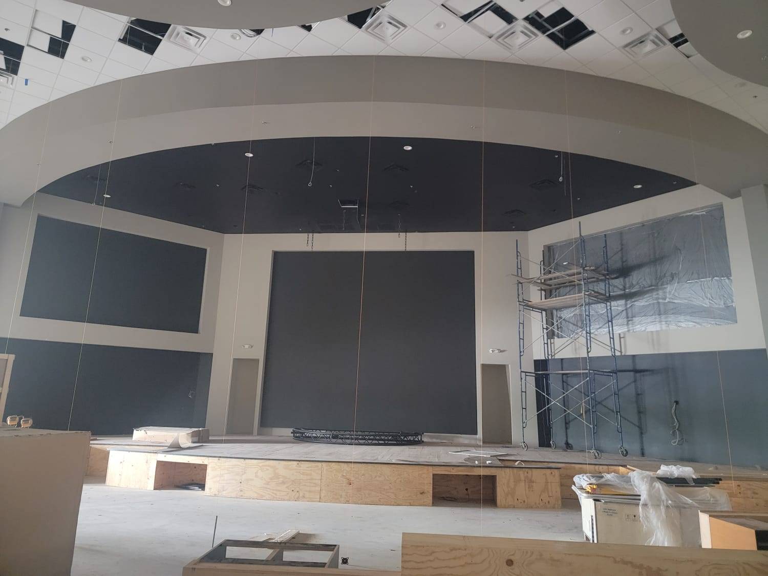 Church sanctuary under construction with bare black wall backing before LED panels